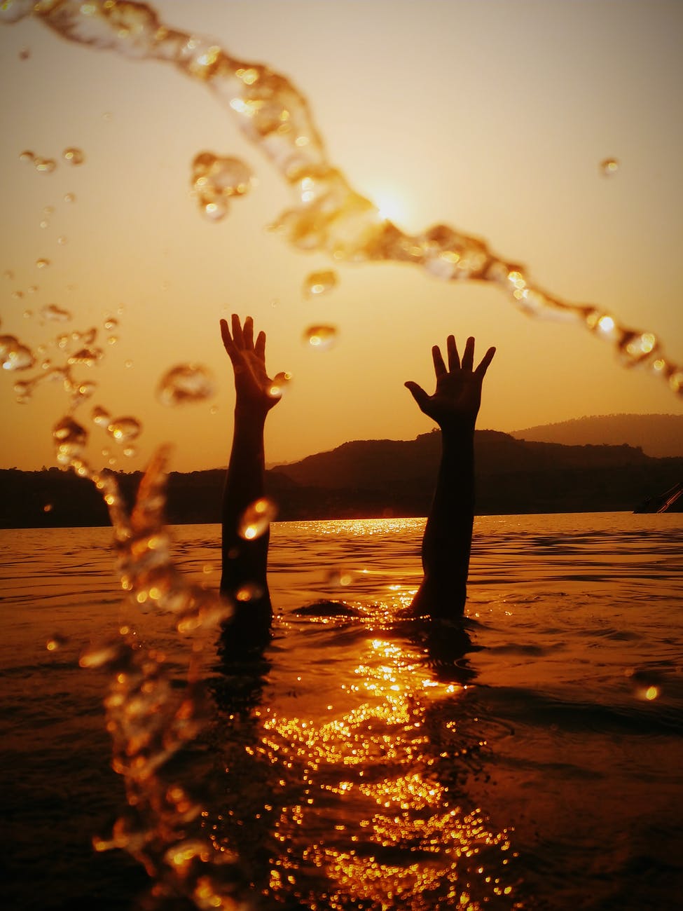 hands above water